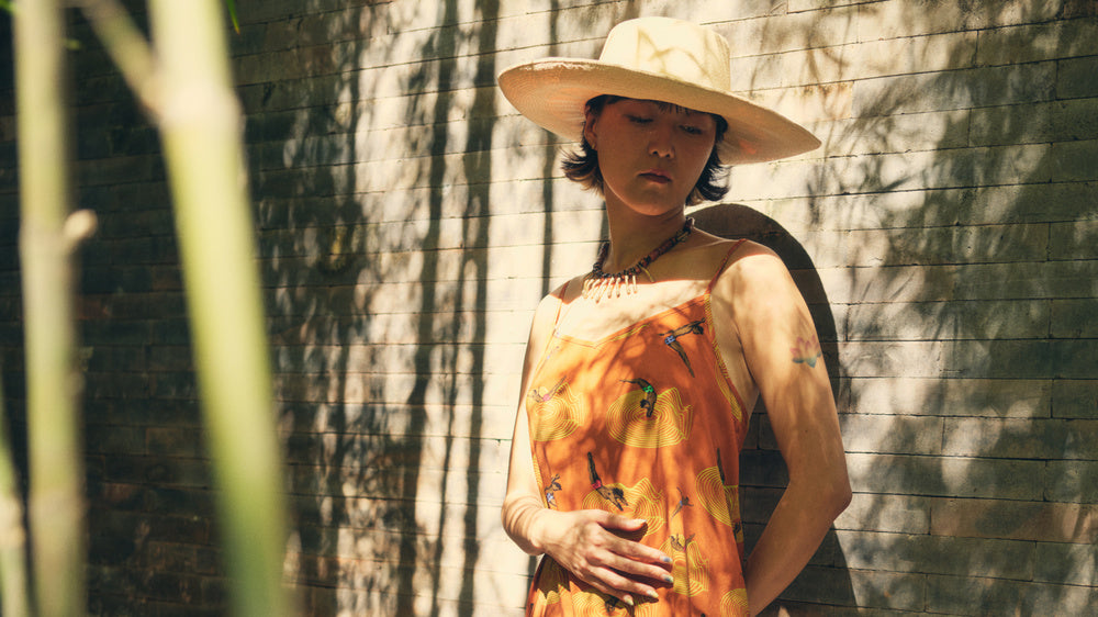 Dambi Kim of (farm)acy wearing Dive In Slip Dress in Orange